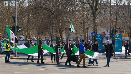 Image showing Pro-opposition activists carrying the Syrian flag on demonstrati