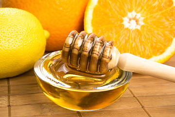 Image showing fresh honey with lemon and orange fruits