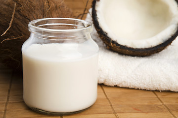 Image showing coconut fruit with a jar filled with coco milk