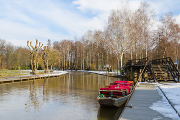 Image showing Boat near the pier on springtime canal