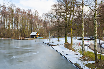 Image showing Springtime european park with frozen channel