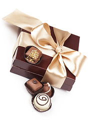 Image showing brown box with candies and golden tape