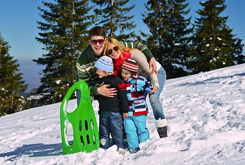 Image showing family having fun on fresh snow at winter