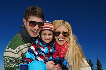 Image showing family having fun on fresh snow at winter