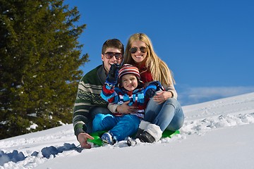 Image showing family having fun on fresh snow at winter