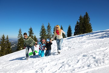 Image showing family having fun on fresh snow at winter