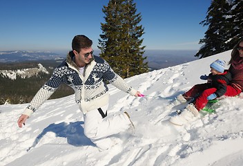 Image showing family having fun on fresh snow at winter