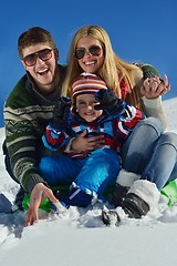 Image showing family having fun on fresh snow at winter