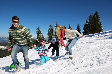 Image showing family having fun on fresh snow at winter