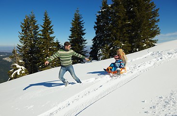 Image showing family having fun on fresh snow at winter