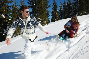 Image showing family having fun on fresh snow at winter