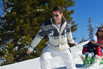 Image showing family having fun on fresh snow at winter