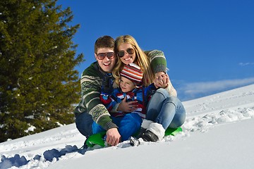 Image showing family having fun on fresh snow at winter