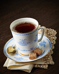 Image showing tea cup and brown sugar cubes