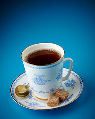 Image showing tea cup and brown sugar cubes