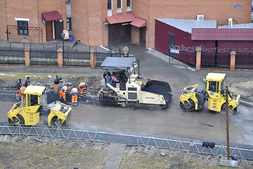 Image showing Special equipment on repair of roads. Bulldozer, asphalt spreade