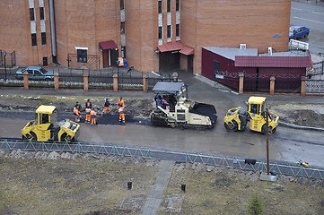 Image showing Special equipment on repair of roads. Bulldozer, asphalt spreade