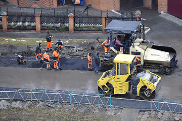 Image showing Special equipment on repair of roads. Bulldozer, asphalt spreade