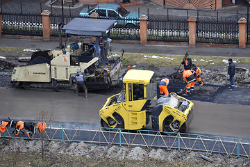 Image showing Special equipment on repair of roads. Bulldozer, asphalt spreade