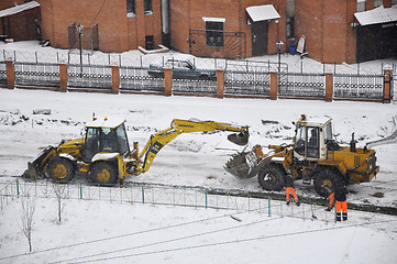 Image showing Special equipment on road construction. Snowfall.