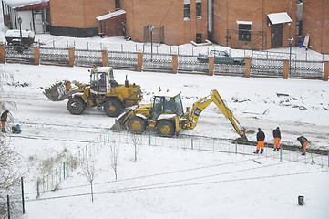 Image showing Special equipment on road construction. Snowfall.