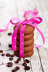 Image showing stack of chocolate cookies tied with pink ribbon and coffee bean