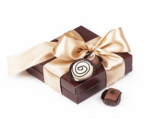 Image showing brown box with candies and golden tape