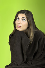 Image showing Thinking woman rolled in a blancket