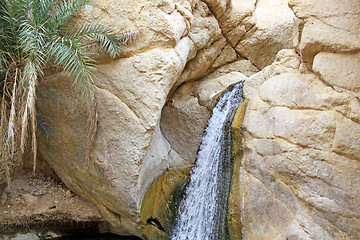 Image showing A waterfall flows from the mountain