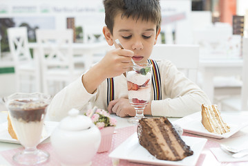 Image showing Child eat strawberry smoothie