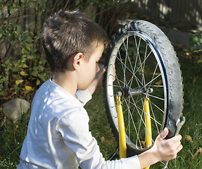 Image showing Kid who fix bikes