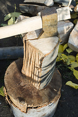 Image showing Ax chopping wood on chopping block