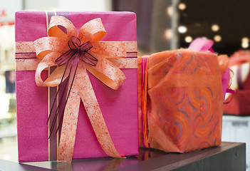 Image showing Pink and red Gift boxes in shopping center