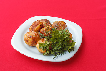 Image showing Baked potatoes with dill and parsley