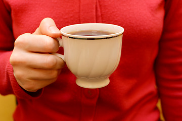Image showing Woman with a cup of black tea in her hand