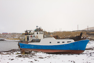 Image showing the boat on the bank of the winter ocean