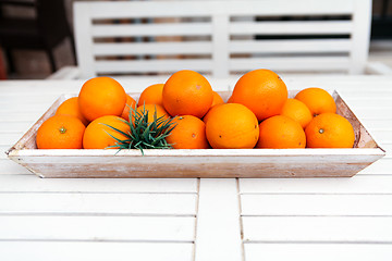 Image showing fresh orange fruits decorative on table in summer