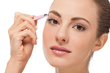 Image showing youtg beautiful woman eyebrow plucking tweezers eyes hair 