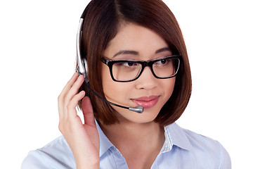 Image showing young smiling asian businesswoman call center agent isolated