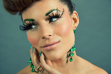 Image showing brunette woman with green jewelery and accssesoires