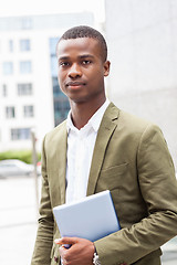 Image showing smiling successful businessman with tablet pc outdoor