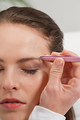 Image showing young beautiful woman eyebrow plucking tweezers eyes hair 