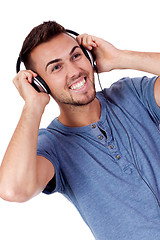 Image showing young attractive man listening to music isolated portrait