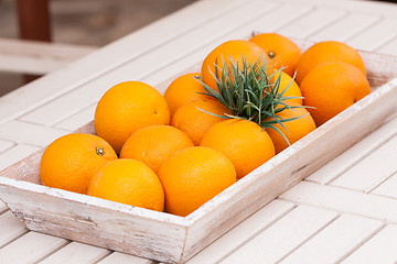 Image showing fresh orange fruits decorative on table in summer