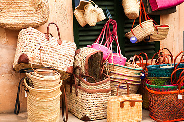 Image showing handmade colorful straw handbags on market sale summer