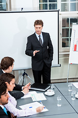 Image showing business team on table in office conference