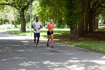 Image showing young couple runner jogger in park outdoor summer