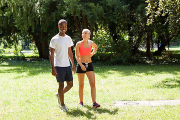 Image showing young couple runner jogger in park outdoor summer