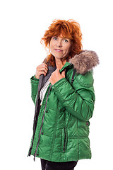 Image showing redhead smiling adult mature woman with geen warm jacket