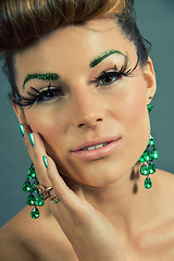 Image showing brunette woman with green jewelery and accssesoires